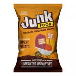 A bright orange bag shows the Junk logo and product name. A clear window reveals thin, curled deep-orange sweet potato crisps. A few crisps lie beside the bag; their surfaces are dusted with fine salt crystals, and simple text indicates the flavor.