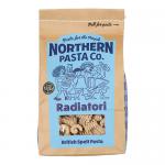 Brightly colored box of Northern Pasta Co. radiatori sits on a grocery shelf. A clear window reveals short, ridged, radiator-shaped pasta pieces. The packaging displays a bold logo and simple typography; a nutrition panel appears on the back while surrounding items blur. soft light highlights ridges