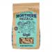 An image shows a clear bag of gigli pasta, revealing short, fluted trumpet-shaped pieces. A white label bears a modest logo and blue accents. The package sits on a neutral surface, warm light highlighting the golden-yellow ridged pasta.