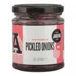 A clear glass jar displays pale pink, thinly sliced pickled onions submerged in brine. A white screw lid tops the jar, and a colorful label wraps around with the J & A Food logo, Vietnamese text and bright graphic accents. Six identical jars sit arranged together. Soft reflections gleam on the glass