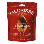 A glossy box labeled Meurisse sits beside a small pile of dark chocolate-covered almonds, each almond gleaming under light. The packaging uses deep browns and gold accents, with a clear window showing the confections.