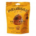 A stack of twelve Meurisse boxes forms a tidy grid, each box wrapped in glossy brown with gold trim. Front panels show glossy milk chocolate clusters studded with whole hazelnuts. The branding sits centered, while soft highlights and shadows add depth and appetizing shine. Subtle gleam on chocolates.