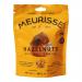 A stack of twelve Meurisse boxes forms a tidy grid, each box wrapped in glossy brown with gold trim. Front panels show glossy milk chocolate clusters studded with whole hazelnuts. The branding sits centered, while soft highlights and shadows add depth and appetizing shine. Subtle gleam on chocolates.