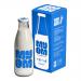 A clear 1000ml Myom glass milk bottle stands upright. It features a cylindrical body that tapers to a narrower neck with a defined rim, smooth reflective glass and subtle embossed branding. Soft highlights and shadows emphasize its contours.