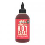 Six identical 260g glass bottles of Wilderbee Gochujang Hot Honey stand in a row on a white background. Each bottle reveals a glossy, deep reddish-honey sauce behind a clean white label with black and red lettering and metallic caps that catch soft studio light.