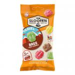 A neat display of a dozen Van Slooten Travel Bags sits on a neutral surface. Each small, glossy pouch shows the Van Slooten logo and a clear window revealing brightly colored sour gummy candies in assorted shapes. Bold, playful graphics and citrus-inspired colors frame the packs.