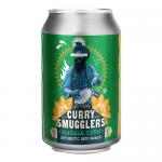 A vibrant snack packet features the Curry Smugglers logo with spice-themed graphics. Golden, crispy masala corn pieces spill beside the bag, showing coarse spice dust, chili flakes and herb flecks against a clean white backdrop.