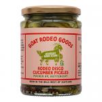Six glass jars stand in a row, each are filled with sliced green cucumbers suspended in clear brine. Shiny metal lids cap the jars. Vibrant labels read 'Rodeo Disco' with bold retro typography, colorful geometric disco patterns and a stylized goat illustration.