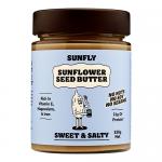 The photo shows six clear jars of golden-brown sunflower seed butter arranged in two rows, each topped with white lids and bright yellow labels reading 'Sunfly' and the product name. Labels feature a sunflower graphic, flavor text, and small nutritional icons. Soft shadows fall beneath jars on wood.