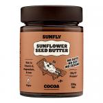 Six glossy jars of Sunfly sunflower seed butter with cocoa sit in neat rows, each 330g jar showing a warm brown spread through a clear band. Bright yellow caps and a sunflower logo decorate cream-and-brown labels, with stylized cocoa beans and seed graphics. Light gleams on lids and casts soft shade