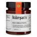 A cluster of twelve 180g glass jars of Kursat's Red Chilli Paste sits on a neutral surface; bright crimson paste peeks through clear glass, textured and glossy. Each jar bears a red-and-white label with the Kursat's logo and simple typography; metal lids reflect studio lights. They sit in neat rows.