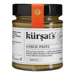 Photo shows twelve 180 g tubs of Kursat's Garlic Paste arranged in a neat grid. Each tub displays a clear label with the brand name and weight, white lids and uniform packaging form a repeating pattern. The paste looks smooth and pale, with slight texture visible on the surface. Shadows fall softly.