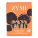 A bright package displays Zymi organic biscuits arranged beside cinnamon sticks, scattered sesame seeds and a sliced orange with a splash of juice. The biscuits show golden-brown edges and textured surfaces, and the brand logo appears prominently on the wrapper. Warm earthy tones and matte finishes.