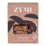 A colorful Zymi Organic biscuit pack rests on a neutral surface. The wrapper shows almonds, sesame seeds and an orange slice beside stylized golden biscuits; a transparent window reveals stacked round cookies, while the Zymi Bakery logo and organic label appear on the top.