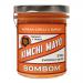 Six identical jars of Bombom Kimchi Mayo sit together. Each clear jar reveals creamy orange-pink mayo, topped by a white lid. Labels feature a bold Bombom logo, kimchi illustration and red-white graphics, with small text and colorful accent details.