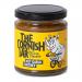 A tight group of six glass jars displays deep-red, chunky hot garlic chutney, visible through clear glass. Each jar wears a cream label with green Cornish script and an illustrated clove of garlic, finished with black metal lids and neat shelf-ready alignment against a plain background. soft studio.