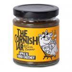 A neat row of six identical clear glass jars sits against a neutral background. Each jar shows amber-brown chutney and a cream label reading The Cornish Jar with apple and cider imagery. Metal lids reflect light; labels include decorative borders and small type. Subtle shadows emphasize jar contours