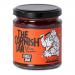 A clear glass jar holds deep red, glossy chilli jam with visible chili flecks. A cream label wraps the jar, featuring a black-and-white Cornish lighthouse logo, bold serif brand name and smaller product text. A silver metal lid seals the jar. The jam shows tiny seeds and a glossy, translucent sheen.