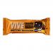 Glossy orange-and-brown wrapper displays the Vive logo and Orange Obsession label. A dense chocolate brownie with shiny ganache and candied orange zest sits beside the package on a rustic wooden board, crumbs and a halved orange accent the scene under soft studio lighting.