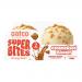 A single Oatco Super Bites Caramelised Biscuit packet sits against a plain background. Brightly colored wrapper shows overflowing caramel drizzle, golden biscuit pieces and scattered oats beside clean brand lettering. A close-up reveals glossy caramel highlights and textured biscuit surface in focus.