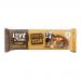 A milk-chocolate–coated peanut caramel bar sits beside its wrapper labeled LoveRaw. The wrapper uses earthy browns and cream, with peanut and caramel graphics. A clean cross-section shows glossy caramel and crunchy peanuts atop a dense nougat, and sits on a white background.