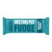 Photo shows a Melting Pot Fudge Salted Caramel bar in a glossy wrapper bearing the brand logo and product name. A broken bar reveals dense, golden-brown fudge with caramel swirls and scattered salt flakes on a neutral background.