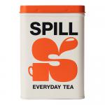 A cylindrical tin sits on a neutral surface, labeled 'Spill Tea' with stylized tea-leaf graphics. The lid tilts open to reveal stacked teabags in paper envelopes. Soft studio lighting casts gentle shadows; fine print and weight marking appear along the tin’s curved front. Background shows soft blur.