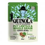 A sealed bag of Quinola wholegrain Puy lentils and expanded quinoa sits upright, its kraft-style paper and warm green label showing product name and brief icons. A clear window reveals small dark green lentils and pale, fluffy quinoa grains scattered at the base. Soft studio light adds gentle shadow.