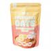 OATCO Overnight Oats Banana Biscuit Boost packages appear in a photo: bright yellow and cream tubs with bold logo, banana and biscuit graphics, and oat clusters on the label. Clear lids reveal creamy oat texture with small banana pieces; multiple tubs sit stacked together.
