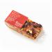 Studio-lit image shows twelve individually wrapped rectangular flapjacks: golden-brown oat bars with a glossy syrup glaze and slightly crumbly edges. Clear plastic wrappers display the Traybakes Bakery logo; bars sit in two neat rows inside a shallow cardboard tray on a white background with sheen.