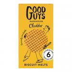 Image shows several golden-brown biscuit melts topped with melted cheddar, some split to reveal gooey orange cheese. Crumbs scatter on a wooden board beside a branded Good Guys Bakehouse box. Soft sidelighting highlights flaky layers and glossy cheese.