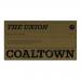 A six-pack of Coaltown The Union No4 tins sits on a grocery shelf. Matte black and deep teal labels show a bold serif logo above a small coal-mine emblem. Metallic edges catch light. Clean white type and subtle linework create a neat, vintage-inspired package layout in soft store lighting. in focus.