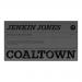 A photo shows a six-pack of Coaltown Jenkin Jones Decaf 200g bags arranged in a neat cluster. Each matte bag bears a bold logo, vintage typography and muted earth-tone graphics featuring coffee beans and coal-mine imagery. Soft studio lighting and shallow depth of field highlight textures. Softwarm.