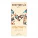 A neat arrangement of twelve identical 90g bars sits against a clean white background. Each bar features a white wrapper with the Montezuma’s logo, elegant typography and subtle gold accents. Soft shadows and even lighting emphasize texture and packaging detail. Subtle glaze highlights wrap and edges.