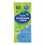 A bright green pouch faces the viewer, displaying scattered popped edamame crisps and a few whole edamame pods dusted with sea salt. The white 'Real Naturals' logo sits near the top, with 'Edamame Pops Sea Salt' flavor text and net weight printed along the lower edge.