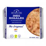 A tall stack of round, golden-brown tortas sits beside a rustic, partially opened yellow wrapper printed with the Ines Rosales logo and illustrations. Crinkled edges and a dusting of sugar highlight each crisp, slightly cracked surface under soft light. A close-up shows flaky layers and light sheen.