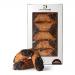 Close-up image shows six Swiss dark chocolate cannoli arranged in a clear tray beside a cream Di Santo & Family Bakery box. Each pastry features glossy dark-chocolate ends, golden crisp shells and a powdered center; chocolate shavings and soft studio light add depth. A small vintage logo is visible.