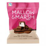 A small glossy pouch shows the Mallow & Marsh logo and playful graphics. The image features mini vanilla marshmallows coated in milk chocolate, some whole and some cut to reveal creamy white centers, arranged against a soft pastel backdrop.