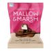 A small glossy pouch shows the Mallow & Marsh logo and playful graphics. The image features mini vanilla marshmallows coated in milk chocolate, some whole and some cut to reveal creamy white centers, arranged against a soft pastel backdrop.