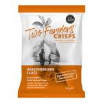 A cardboard carton holds twelve green-and-gold packets of Two Farmers Herefordshire Sauce crisps. Bold white logo fronts each bag with stylized potato chips imagery, flavor name in red script, and rustic farm illustrations along the lower edge.