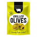 A rustic jar of grilled olives sits open on a wooden board, glossy dark-green and brown fruits showing char marks and shimmering oil. Red chili flakes and fresh rosemary needles scatter nearby, while warm light casts soft highlights and deep, textured shadows across the scene. A small fork lies now.