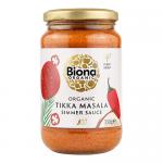 A set of six identical Biona Organic Tikka Masala simmer sauce jars. Each jar shows a warm orange-red sauce through clear glass, topped by a white screw lid. The front label features the green Biona Organic logo, the product name and small illustrations of tomatoes and spices.