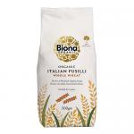 A clear-front package displays tightly coiled whole-wheat fusilli spirals in warm brown tones; a kraft-paper label with the Biona logo and organic text sits above, accented by green highlights and simple typography. Lighting casts soft shadows, emphasizing texture and ridges.