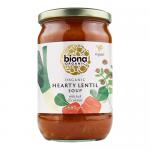 A six-pack of Biona Organic Hearty Lentil Soup shows six metal cans with cream labels, the green Biona logo and a photo of warm brown lentil soup in a bowl; clear product name and ingredient imagery appear on a plain background.