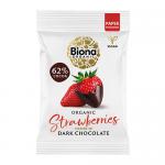 A green-accented pack shows glossy dark chocolate clusters studded with bright pink freeze-dried strawberry pieces. The Biona logo and organic wording appear on the pack alongside an image of scattered chocolate-covered strawberry bites on a white background.