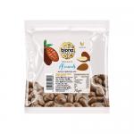 A glossy pack of Biona Organic Milk Chocolate Covered Almonds (70 g) shows the Biona logo and a green organic seal. The design features a photo of milk chocolate-coated almonds spilling from a bowl against a brown and cream background, with clear product name text and simple graphic accents. Subtle.