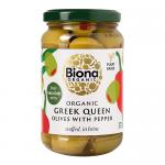 A clear glass jar displays plump green Queen olives, each filled with bright red pepper pieces, suspended in pale brine. The label shows organic branding and simple graphics; a metal lid seals the jar and light reflects off the curved glass.