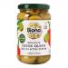 A clear glass jar displays plump green Queen olives, each filled with bright red pepper pieces, suspended in pale brine. The label shows organic branding and simple graphics; a metal lid seals the jar and light reflects off the curved glass.