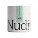 A set of six matte green tins labeled 'Nuditea' lines a shelf against a soft beige background. One tin opens to reveal finely ground, vivid emerald matcha. Simple Japanese characters and a small white 30g mark appear on the minimalist labels; a wooden scoop and a dusting of powder sit nearby always.