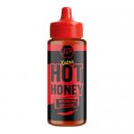Close-up photo shows a 260g glass jar of JD’s Hot Honey XXTRA Hot Habanero. Golden-orange honey with suspended red chili flakes fills the jar. A black screw lid caps a bold red-and-black label featuring the brand name and a stylized habanero flame on white. Soft light creates mild glass reflections.